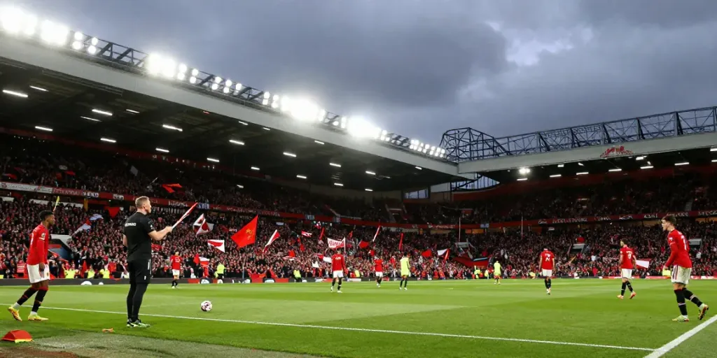 Manchester United vs Liverpool match showcasing intense rivalry with fans, players, and coaches in action.
