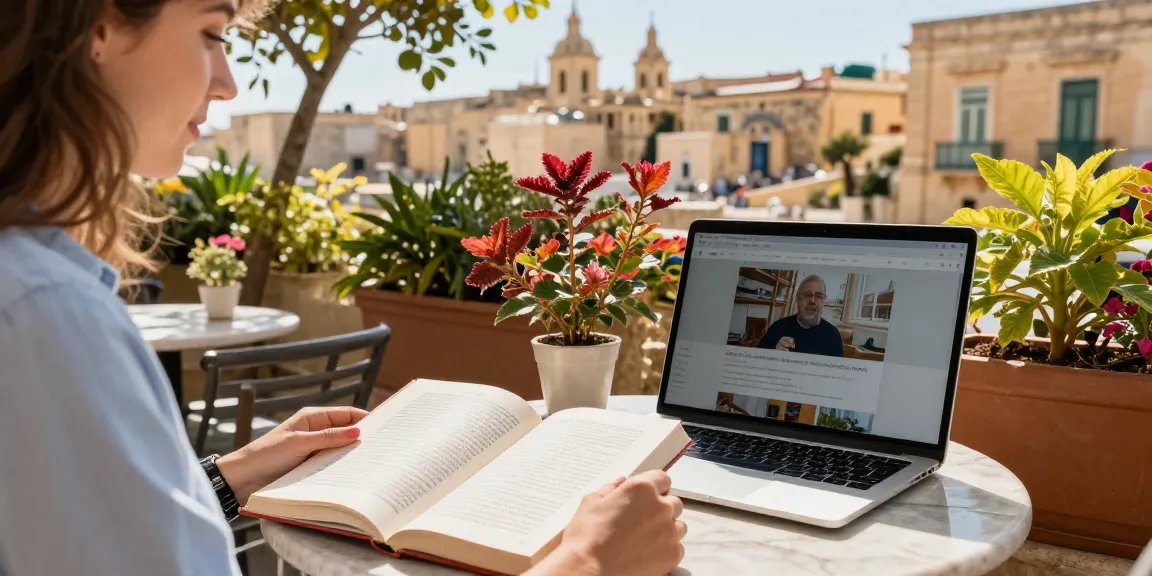 Cours d'anglais à Malte, étudiant apprenant dans un café avec un livre et un ordinateur portable.